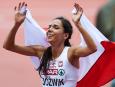 Owinięta w biało-czerwoną flagę Polka Joanna Jóźwik cieszy się po zdobyciu brązowego medalu w finałowym biegu kobiet na dystansie 800 metrów